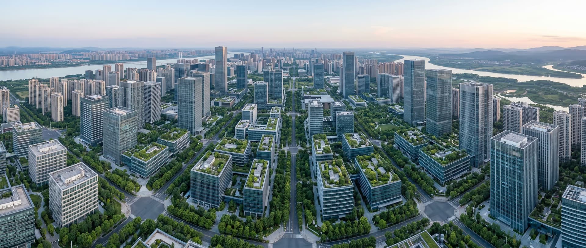 Aerial view of a modern business district with rooftop gardens, representing GDV Holdings' asset-light, environmentally conscious operating model
