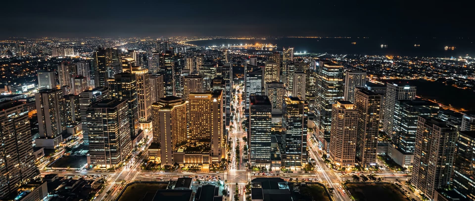 Bonifacio Global City skyline at night, representing GDV Holdings' multi-currency international reach across the Philippine financial district and global markets