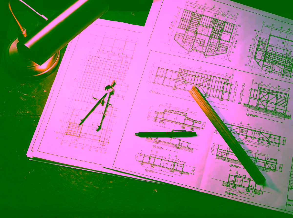 Engineering drawings and draftsman instruments on a dark desk — conveying the precision and structural discipline behind GDV Holdings capital deployment frameworks